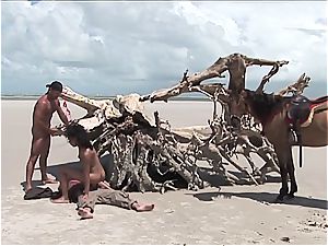 crazy latin lady gets two cocks on the beach